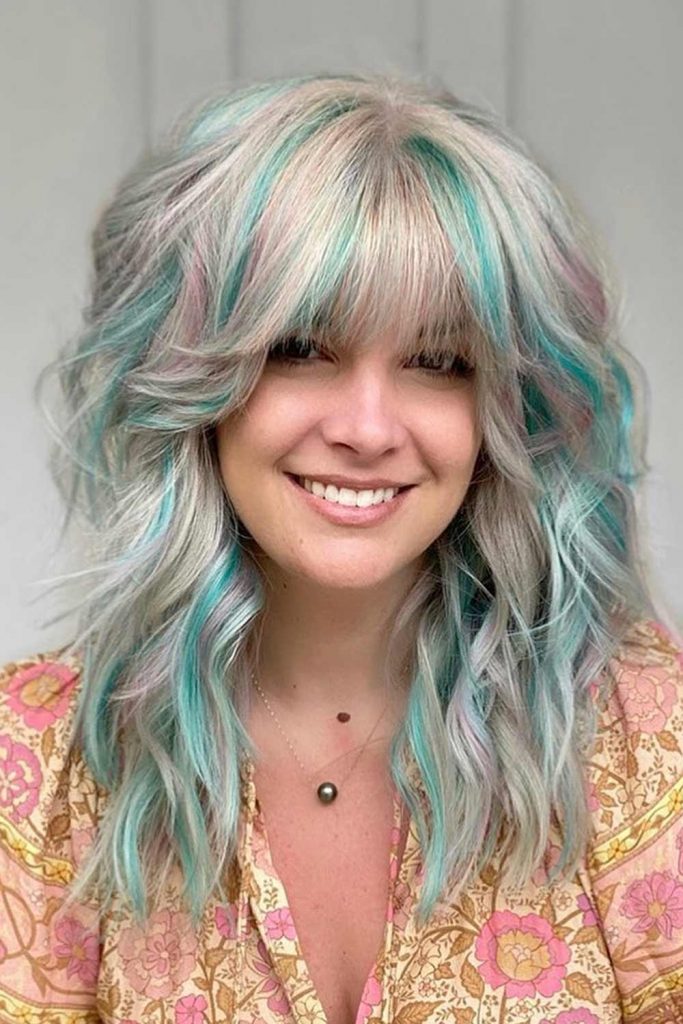 Voluminous Blonde Hair with Green Highlights